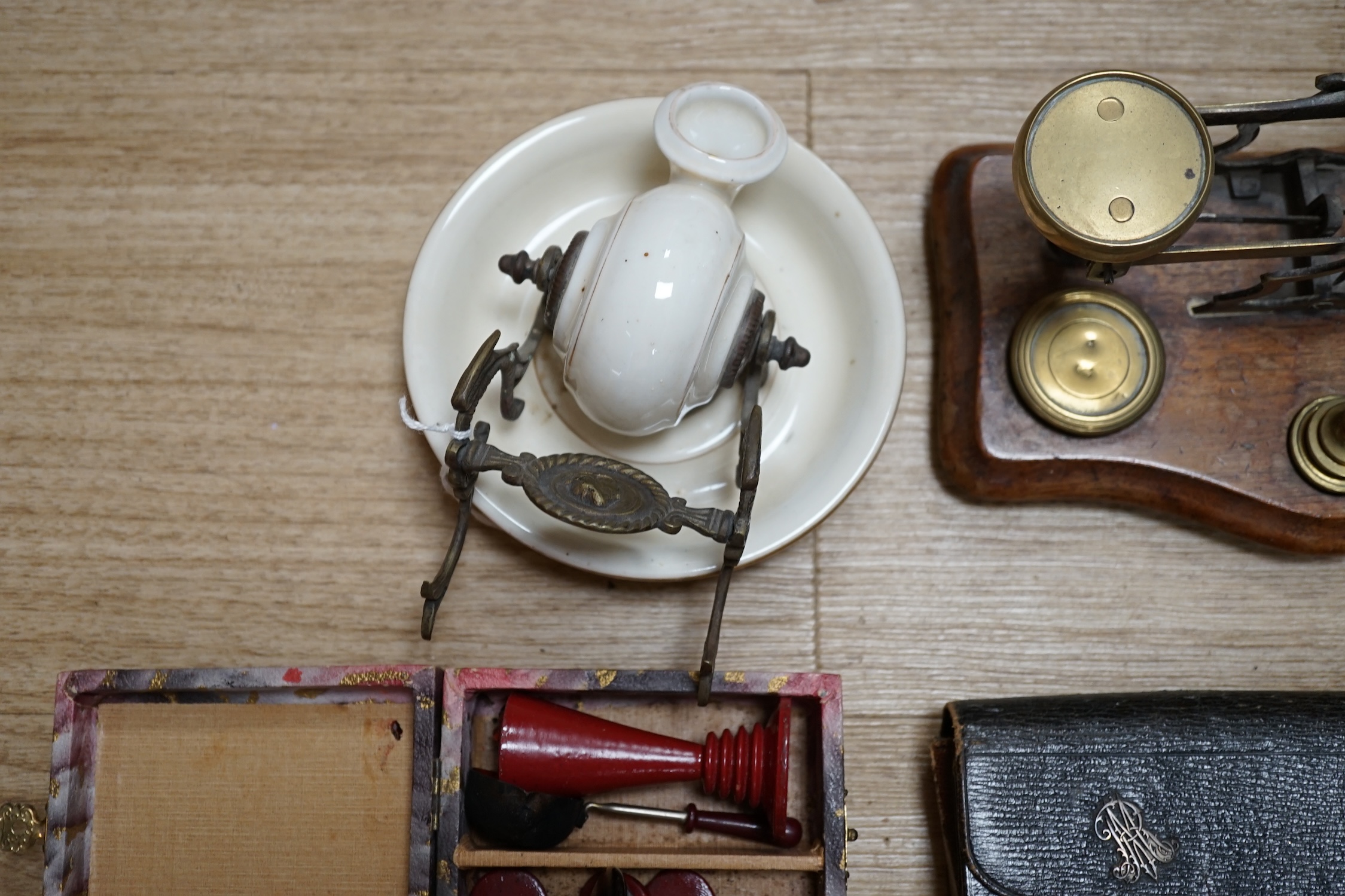 A pair of brass letter scales, a novelty ink pot, a Gladstone bag, a maple framed sketch, a googlie eyed doll’s head, a tin plate Jumbo toy, Dominoes, boxed seal kit and a leather travelling stationary case etc., scales